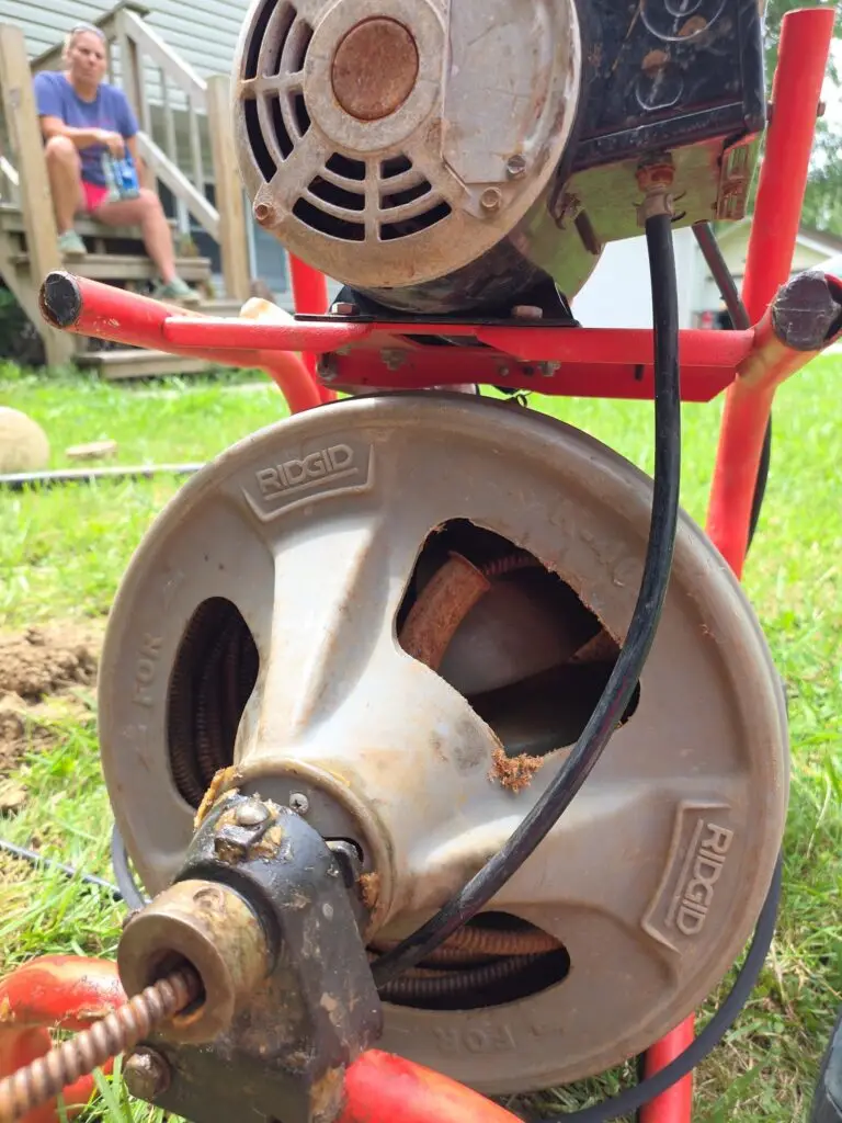RIDGID drum-style drain cleaning machine on a residential lawn