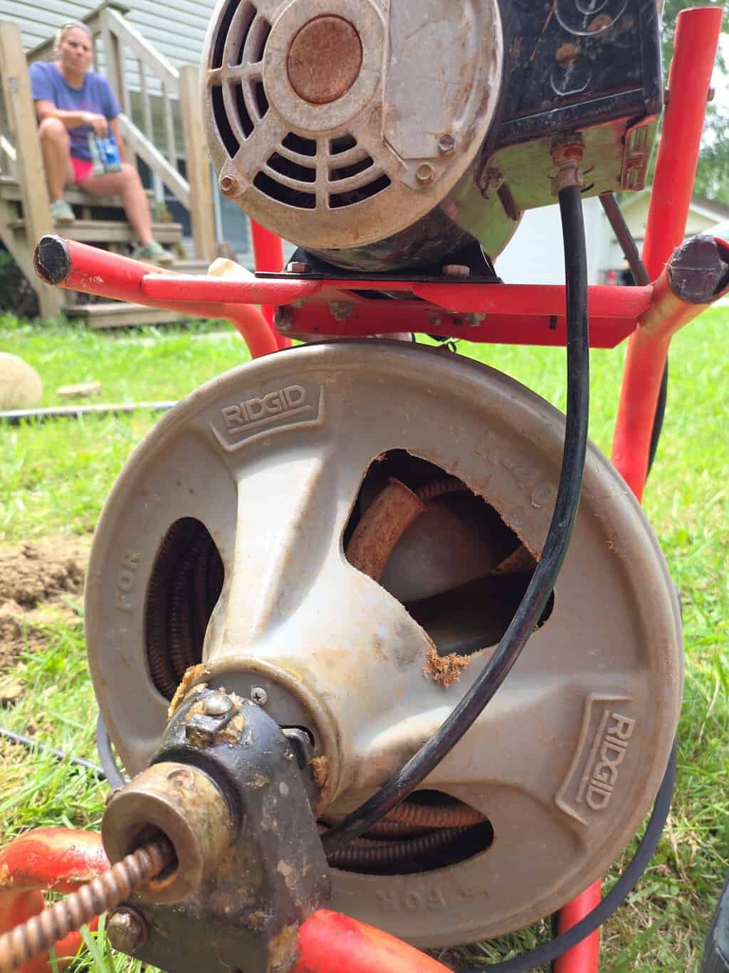 RIDGID drum-style drain cleaning machine on a residential lawn